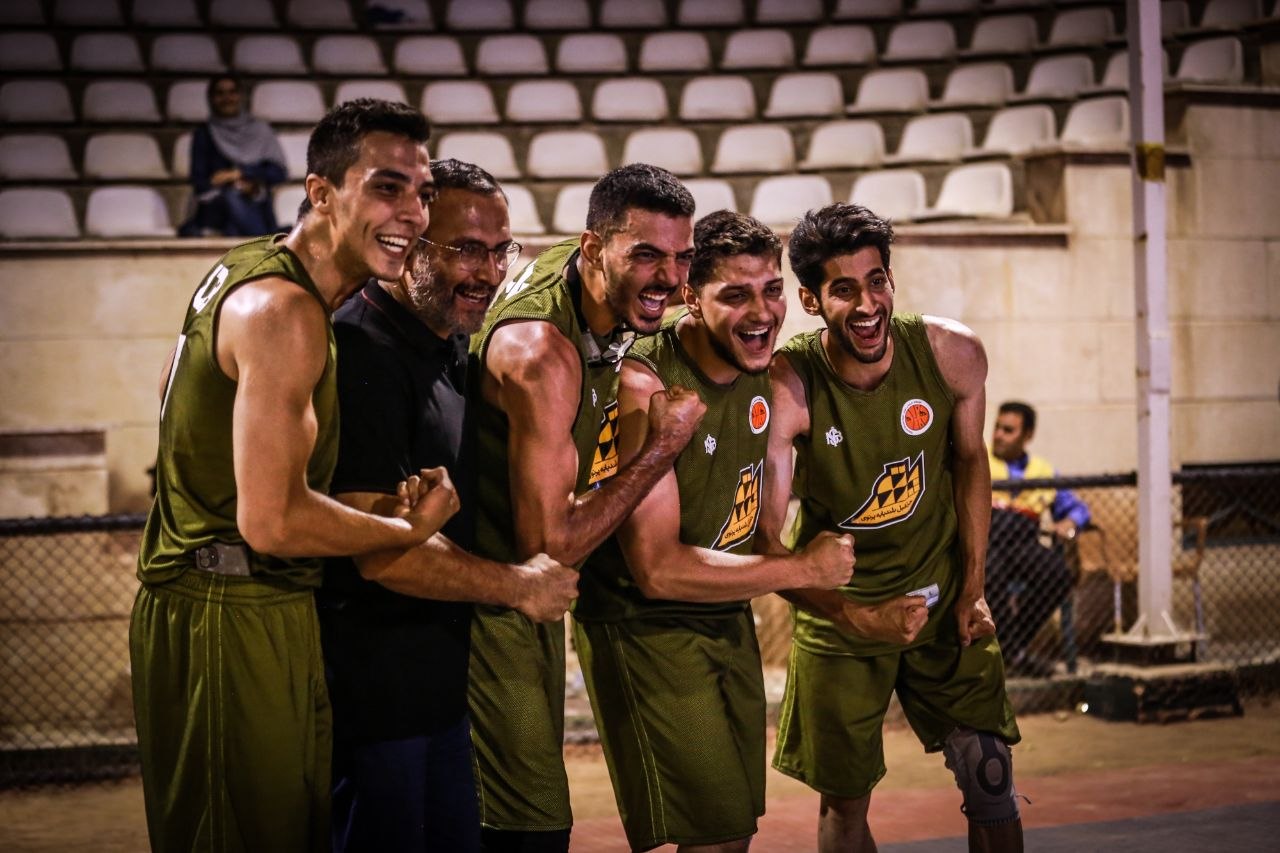 Victory Huddle · Coach Jafari with Green-Jersey Squad