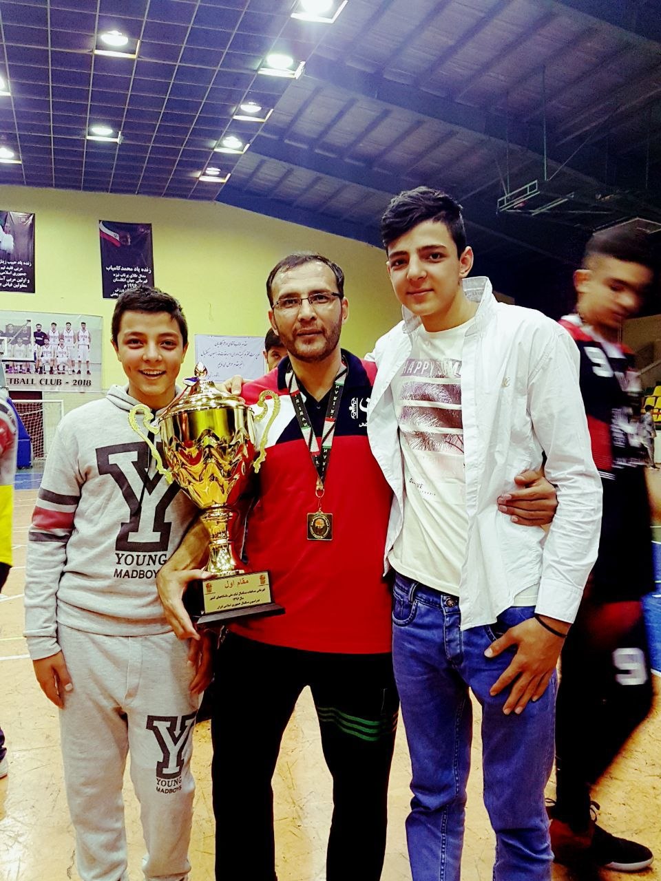 Coach Jafari with Sons Mahdi & Alireza · First-Place Trophy