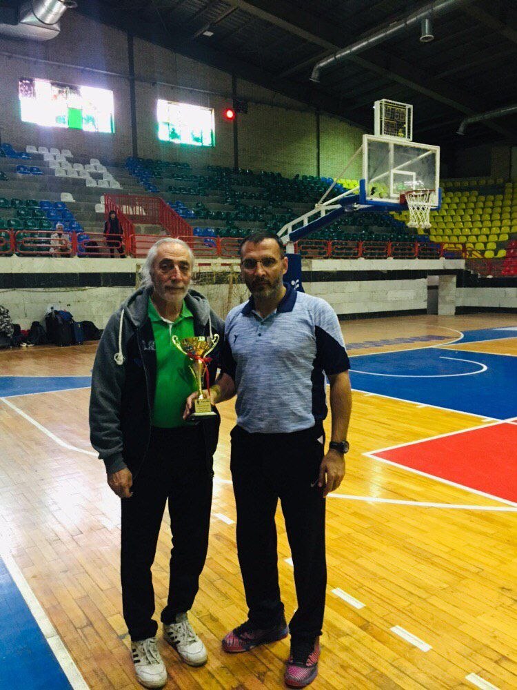 Coach Jafari with Veteran Holding the Cup